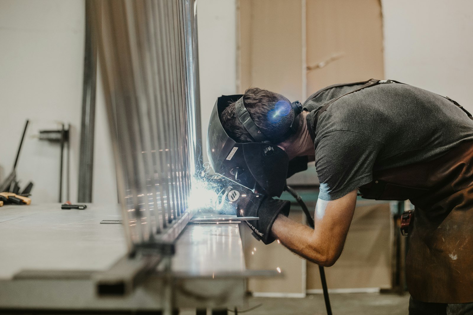Welder fabricating stainless steel sight glass assemblies